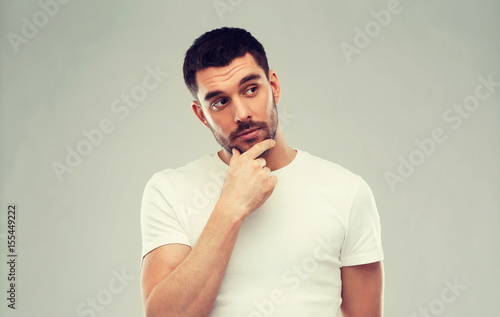man thinking over gray background © Syda Productions