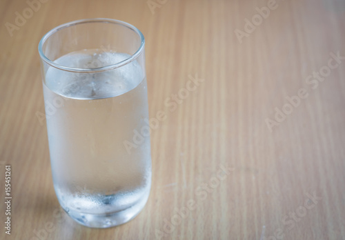 Glass of drink water on wooden table,selective focus.