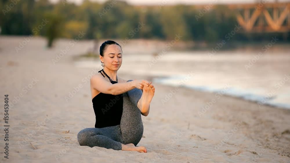 Girl doing asanas on the beach Girl doing asanas on the beach