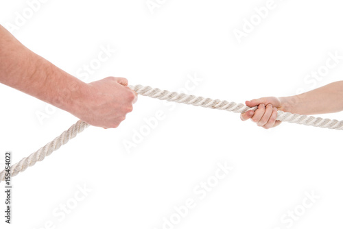 Close-up partial view of father and son pulling rope, family problems concept