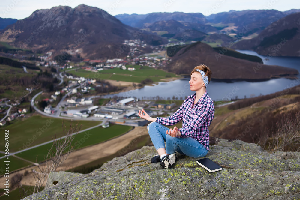 Naklejka premium A woman have a relax on the top of mountain