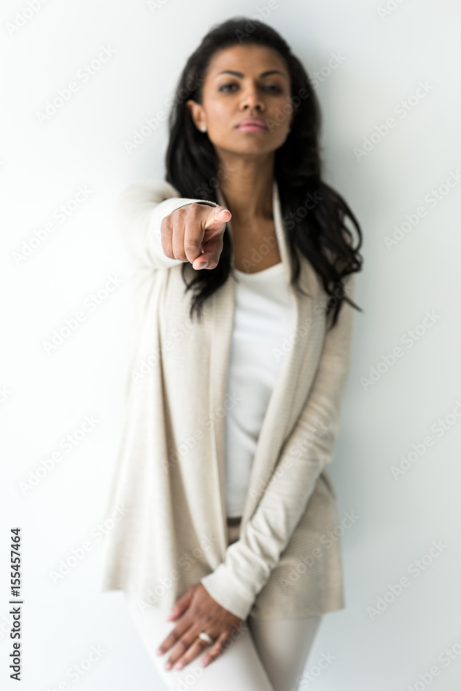 attractive serious african american woman pointing isolated on white attractive serious african american woman pointing isolated on white