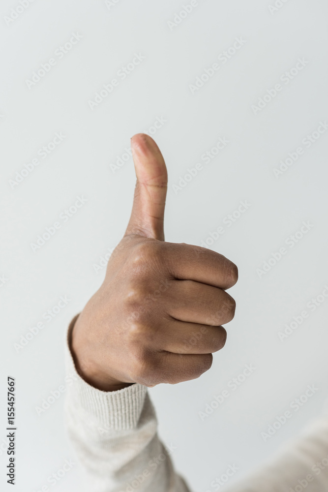 cropped view of african american woman showing thumb up isolated on white