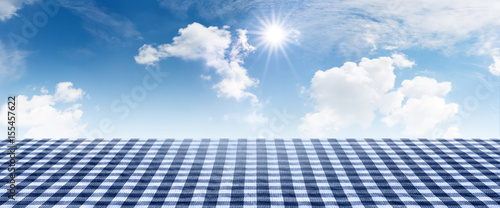 Blue checkered tablecloth with summer sky