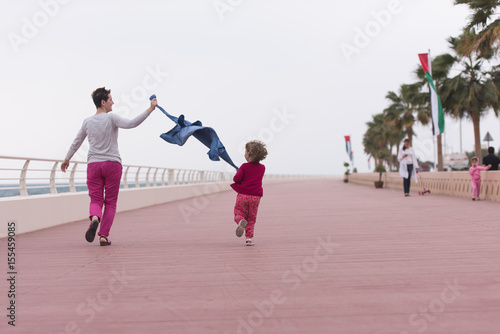 mother and cute little girl on the promenade by the sea © .shock