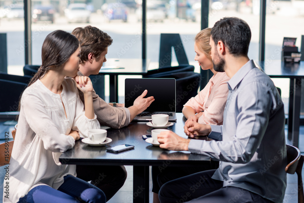 business team on meeting discussing project with laptop in cafe, business lunch concept business team on meeting discussing project with laptop in cafe, business lunch concept