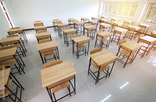 School classroom with desks chair wood, and blackboard in high school thailand, vintage tone education concept