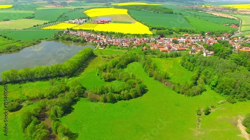 Aerial view to rural landscape with Uhlava river and fish pond. Luzany village near Pilsen in Czech Republic. Spring in Central Europe. photo