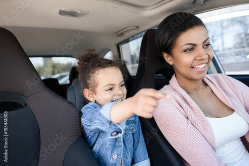 little african american girl with mother sitting in car © LIGHTFIELD STUDIOS
