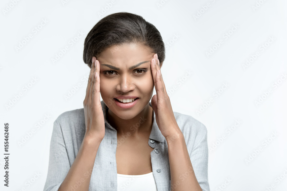 young casual african american woman with headache isolated on white young casual african american woman with headache isolated on white