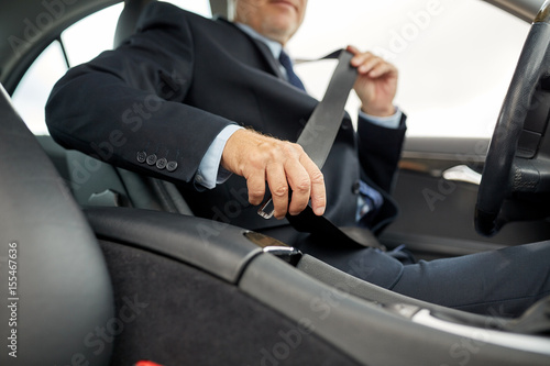 senior businessman fastening car seat belt © Syda Productions
