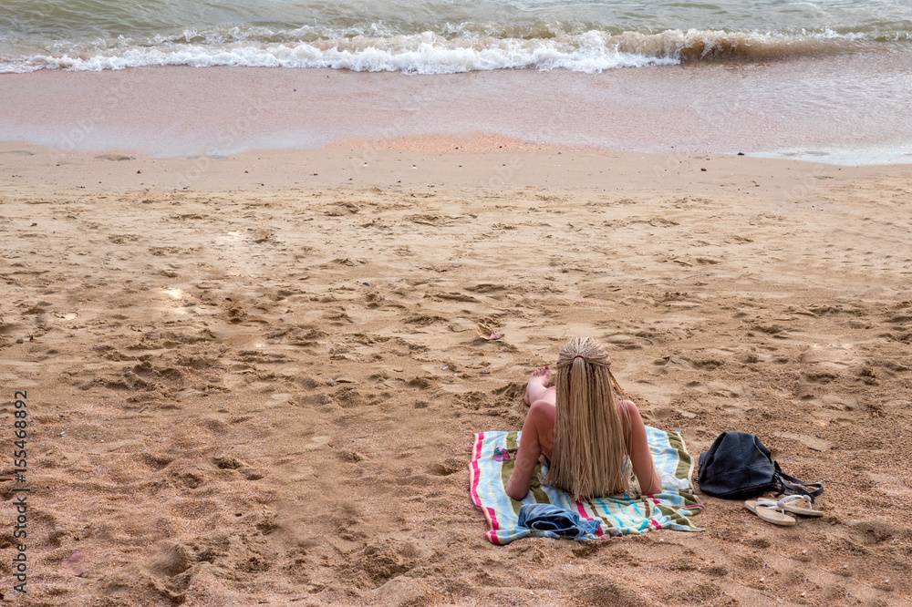 The tourist woman sunbath on beautiful beach
The tourist woman sunbath on beautiful beach
