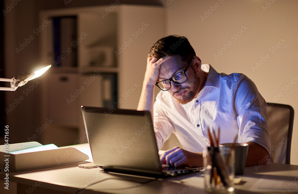 businessman with laptop thinking at night office businessman with laptop thinking at night office