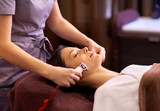 woman having hydradermie facial treatment in spa