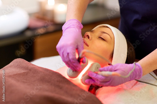 young woman having face microdermabrasion at spa