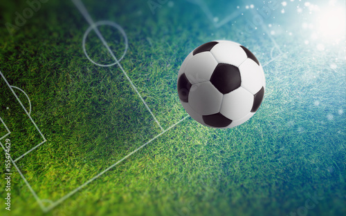 Fototapeta Naklejka Na Ścianę i Meble -  Soccer ball on green soccer field