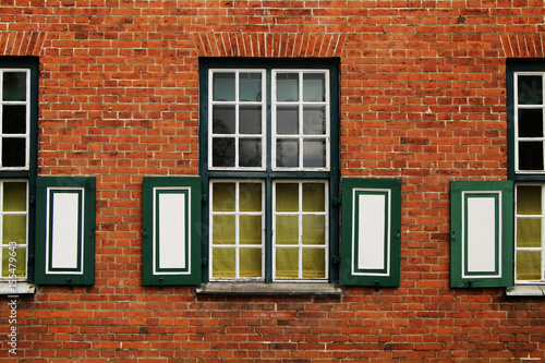 Fragment of a building with windows of an ancient palace of red brick