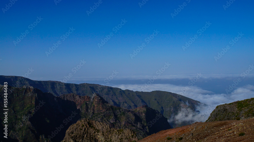 Madeira - Mountain Pico do Arieiro with red rocks and clouds beneath
