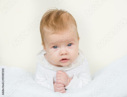 Portrait of a newborn baby girl lying on her stomach
