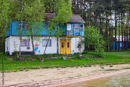 Old two-storey house on the shore of the lake. Pisochne ozero. Volyn region. Ukraine © evgenij84