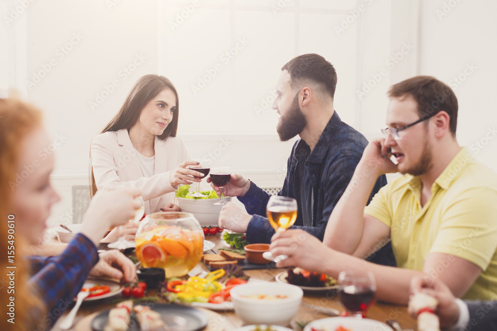 Group of happy young people at dinner table, friends party Group of happy young people at dinner table, friends party