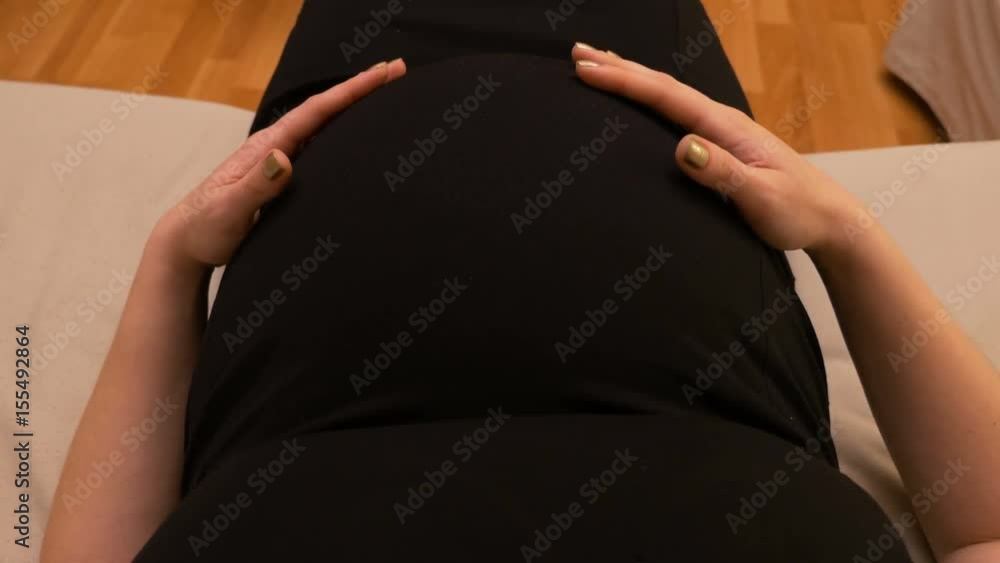pov-point-of-view-of-pregnant-woman-belly-wearing-engagement-ring-and