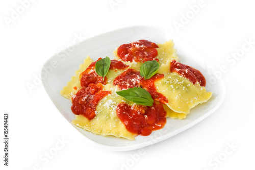 Ravioli with tomato sauce and basil isolated on white background