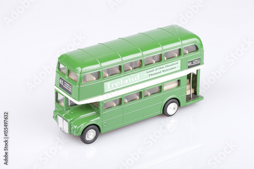 Irish double decker toy on a white surface. Ireland green bus isolated on white background.