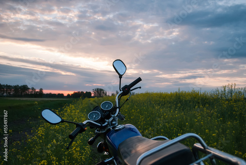 Motorcycle at sunset, rapeseed field,