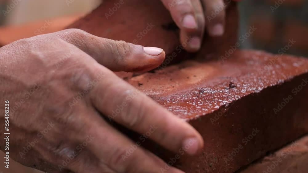 Strong man's hands building a house Strong man's hands building a house