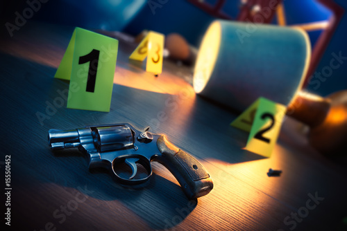 Obraz na plátně dramatic lit crime scene with gun and markers on the floor