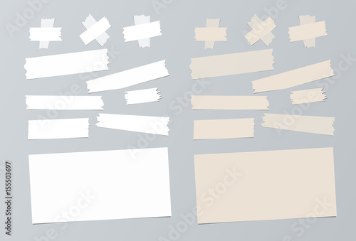 Set of white and beige note paper and adhesive sticky tape ripped pieces on grey background 