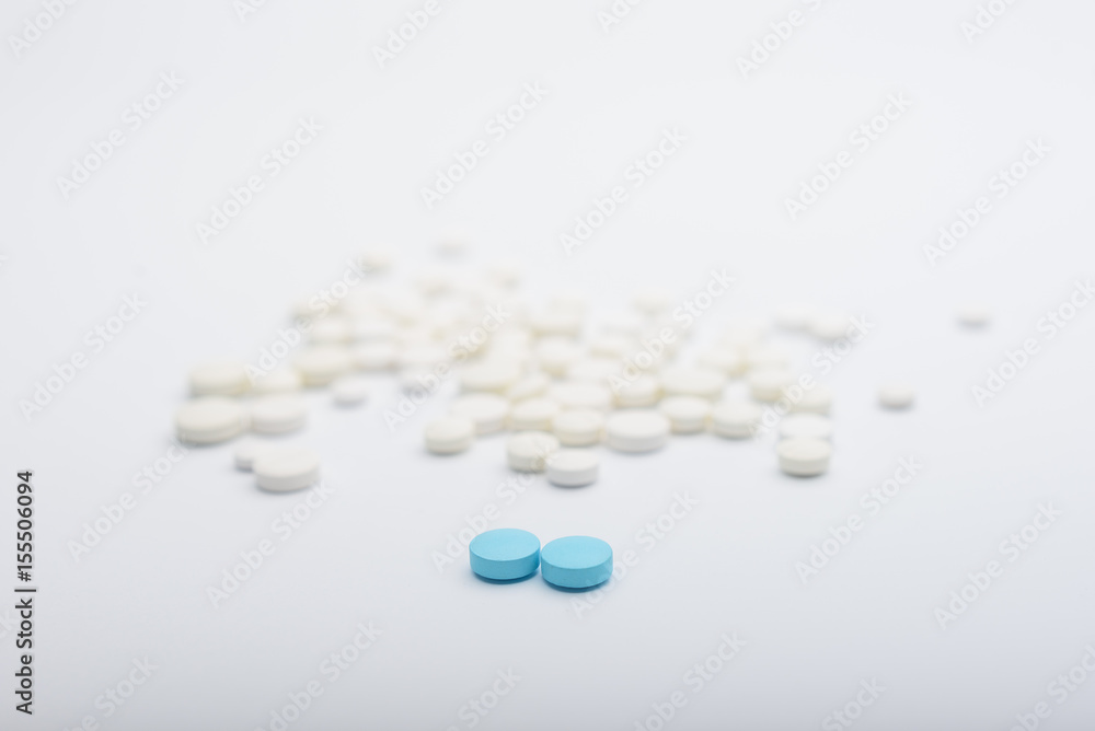 two blu and white pills medicine on white background two blu and white pills medicine on white background