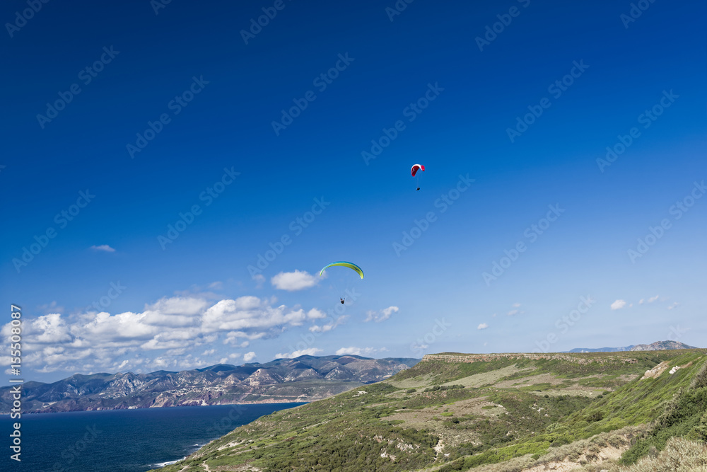 Paragliding in blue cloudy sky Paragliding in blue cloudy sky