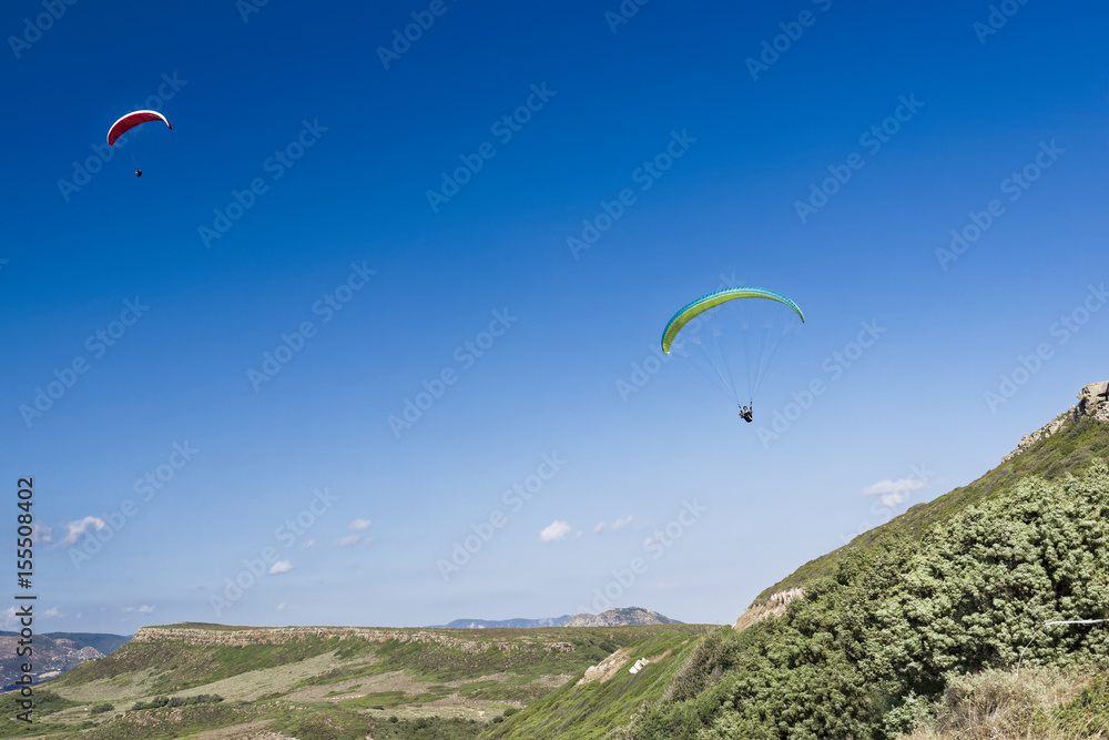 Paragliding in blue cloudy sky Paragliding in blue cloudy sky