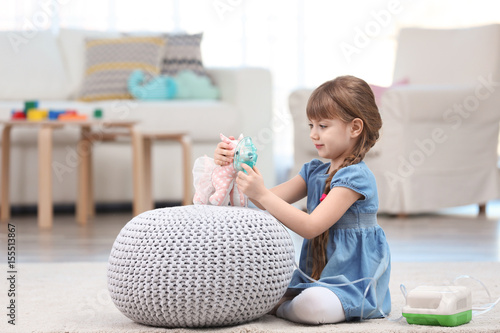 Cute little girl playing wi...