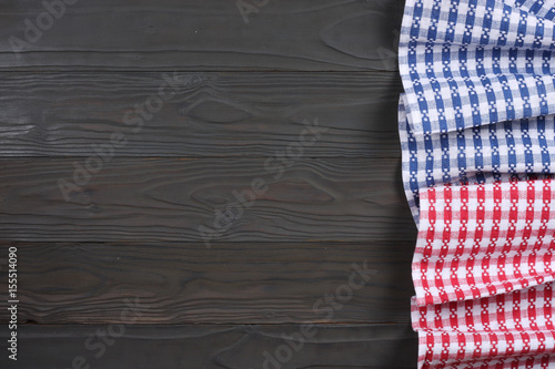 blue and red cloth on dark wooden background with copy space. Top view.
