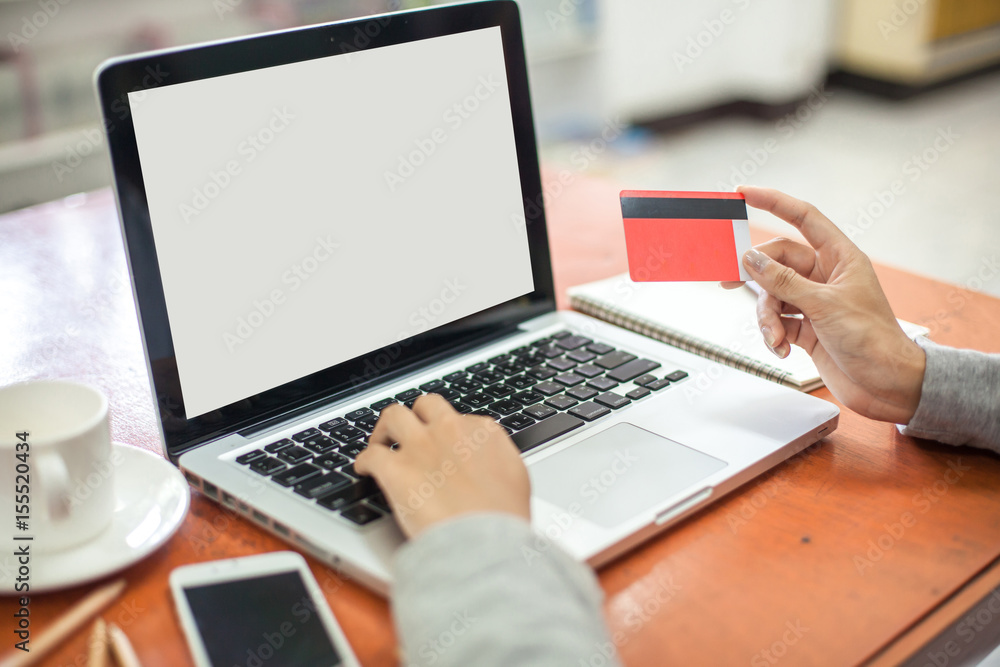 Hand holding credit card and using laptop. Online shopping Hand holding credit card and using laptop. Online shopping