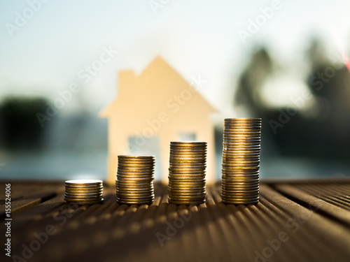 Saving to buy a house that stack gold coin growing ,saving money or money growth concept