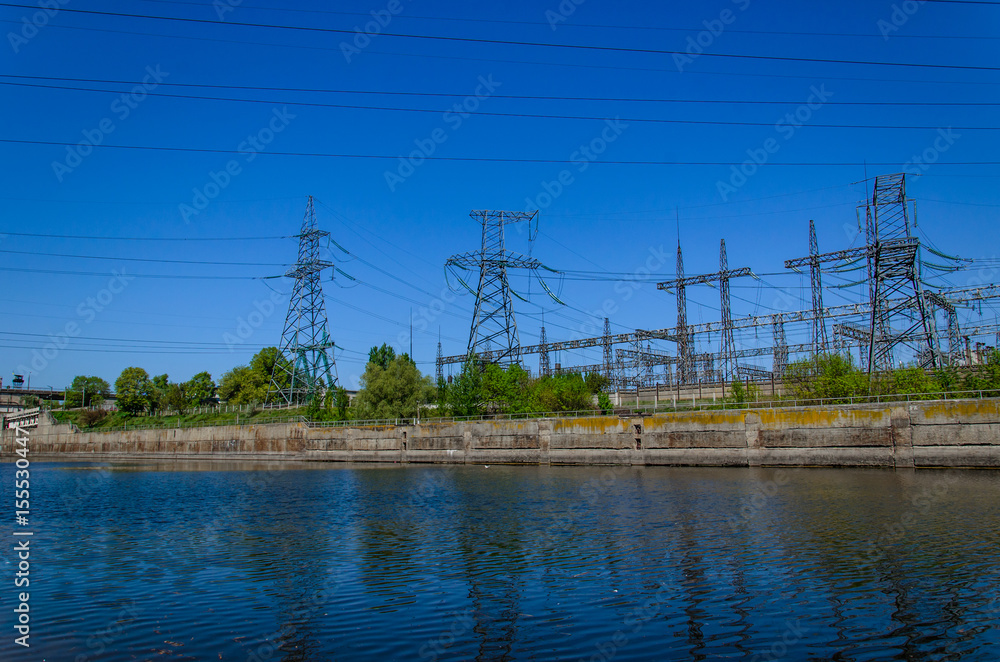High voltage power lines and towers against sky