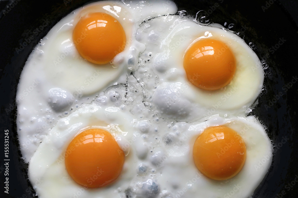 The window is reflected in the yolks of boiled eggs on a black background. Scrambled eggs with the window bindings reflected in it. The window is reflected in the yolks of boiled eggs on a black background. Scrambled eggs with the window bindings reflected in it.