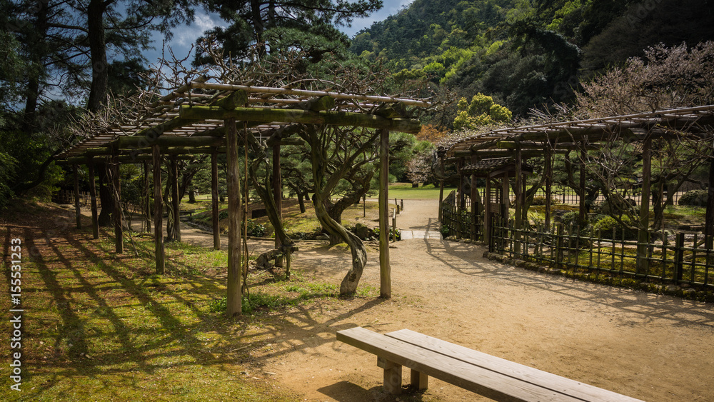 A couple walks In the Ritsurin Garden in Takamatsu City A couple walks In the Ritsurin Garden in Takamatsu City