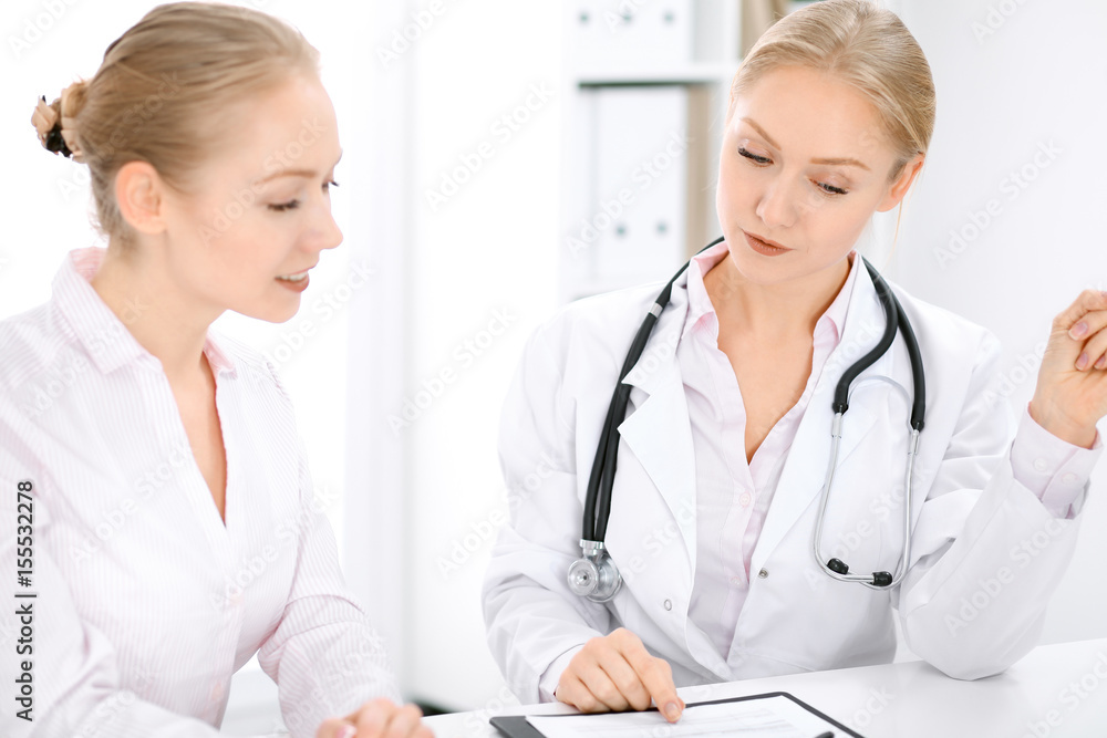 Doctor and patient sitting at the desk Doctor and patient sitting at the desk