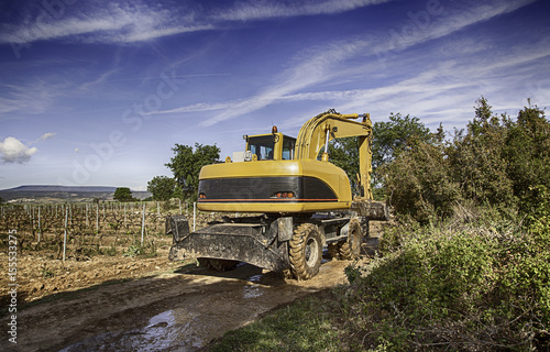 Excavator in field