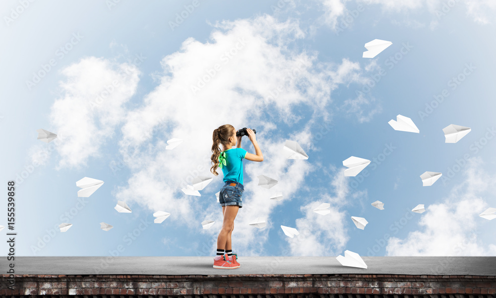 Concept of careless happy childhood with girl of school age looking in future Concept of careless happy childhood with girl of school age looking in future