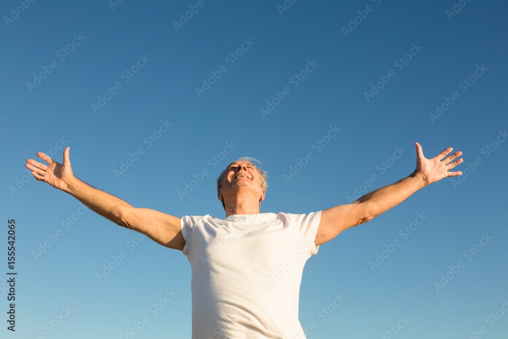 Low angle view of man with arms outstretched Low angle view of man with arms outstretched