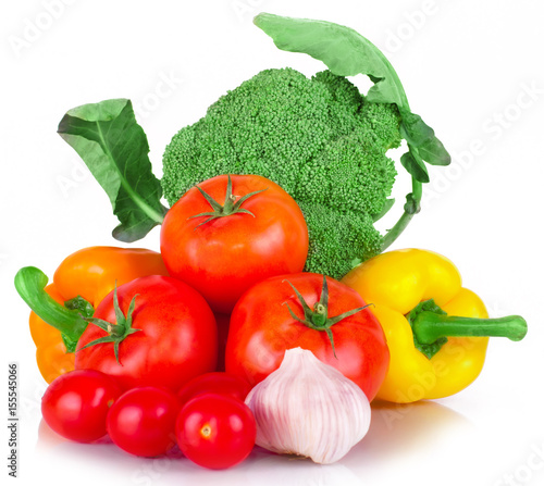 vitamin set of vegetables from the  large broccoli green leaves red ripe tomatoes  orange and yellow peppers and purple garlic with green sprigs of fresh isolated on white background