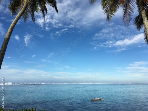 Small pirogi in the clear blue water of the lagoon of Papara, Tahiti, French Polynesia