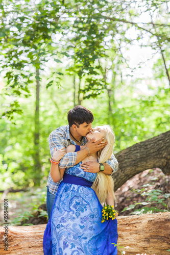 Young kissing couple against the nature