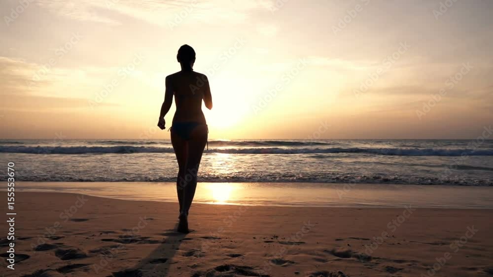 Silhouette of woman in bikini running towards sea during sunset, super slow motion 240fps
Silhouette of woman in bikini running towards sea during sunset, super slow motion 240fps